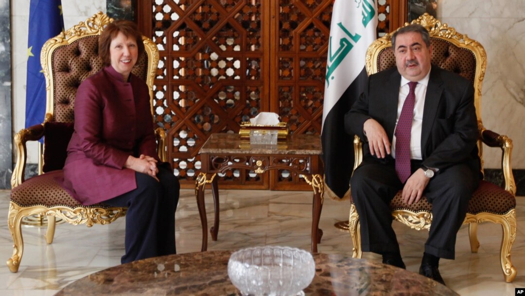 Iraq's Foreign Minister Hoshyar Zebari, right, meets with EU foreign policy chief Catherine Ashton upon her arrival at Baghdad International Airport in Iraq, May 23, 2012.