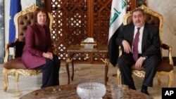 Iraq's Foreign Minister Hoshyar Zebari, right, meets with EU foreign policy chief Catherine Ashton upon her arrival at Baghdad International Airport in Iraq, May 23, 2012.