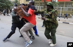 FILE - An activist is arrested by police officers during a protest against high cost of living and new taxes in downtown Nairobi, Kenya, Tuesday, Aug. 8, 2023.