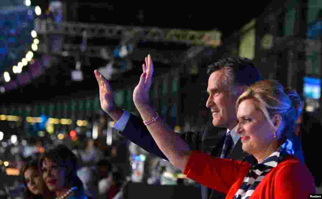 Mitt Romney and his wife Ann wave during the opening ceremony of the London 2012 Olympic Games at the Olympic Stadium London, July 27, 2012.