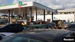 Drivers wait in line to refuel their vehicles at a Nigerian National Petroleum Corporation station in Abuja, Nigeria, on Sept. 2, 2024. 