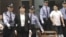 Gu Kailai is escorted to court by police, Aug. 9, 2012.