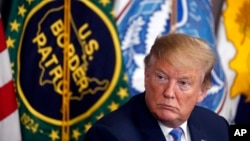 FILE - Then-President Donald Trump participates in a roundtable on immigration and border security, at the U.S. Border Patrol Calexico Station in Calexico, California, April 5, 2019.