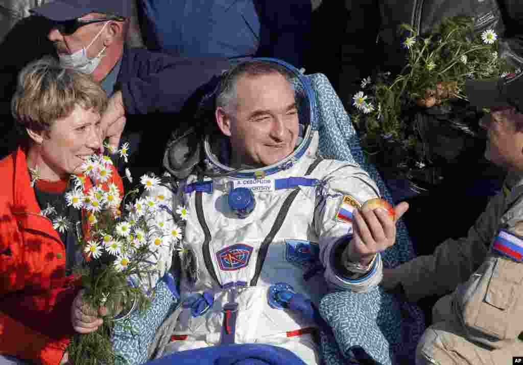 Russian cosmonaut Alexander Skvortsov holds a traditional apple after landing in the Soyuz TMA-12M space craft near the city of Zhezkazgan, Kazakhstan, Sept. 11, 2014.