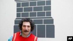 FILE - Artist Michael Rakowitz poses for the media at the National Gallery in London, March 21, 2017.