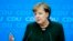 FILE - German Chancellor Angela Merkel addresses a new conference after a board meeting of her Christian Democratic Union party at the headquarters in Berlin, Nov. 27, 2017. 
