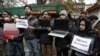 FILE - Kashmiri journalists display laptops and placards during a protest demanding restoration of internet service, in Srinagar, Nov. 12, 2019.