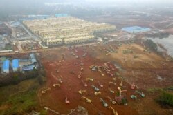 Excavators and bulldozers are seen at a construction site where a hospital is being built to treat those affected by a new strain of coronavirus, on the outskirts of Wuhan, China, Jan. 24, 2020.