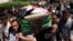 Residents carry a coffin during the funeral of an Iraqi soldier in Baghdad, April 25, 2013.