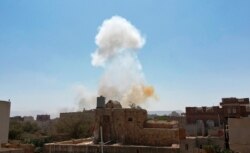 Smoke rises after Saudi-led airstrikes on an army base in Sanaa, Yemen, Mar. 7, 2021.
