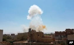 Smoke rises after Saudi-led airstrikes on an army base in Sanaa, Yemen, Mar. 7, 2021.