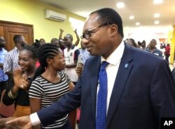 FILE - In this photo taken Tuesday, Dec. 11, 2018, presidential candidate Noel Tshiani Muadimvita greets supporters at a campaign rally in Kinshasa, Congo.