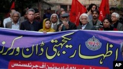 Pakistani journalists and rights activists hold a banner reading as "Solidarity with Dawn Workers" during a demonstration in Islamabad, Pakistan, Dec. 5, 2019.