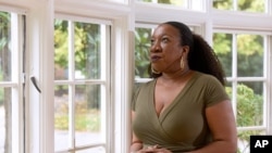 Tarana Burke, founder and leader of the #MeToo movement, stands in her home in Baltimore Oct. 13, 2020, as the movement marks the third year since it received global recognition.