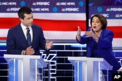 FILE - Democratic presidential candidates, Sen. Amy Klobuchar, D-Minn., right, speaks as former South Bend Mayor Pete Buttigieg looks on during a Democratic presidential primary debate in Las Vegas, Feb. 19, 2020.