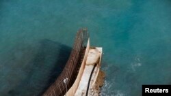 Border fence separating Morocco and Spain's north African enclave Melilla runs all the way to the sea, Dec. 3, 2013.