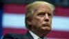 FILE - President-elect Donald Trump stands on stage in Grand Rapids, Michigan, Dec. 9, 2016.