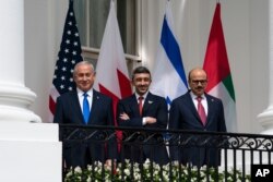 Israeli Prime Minister Benjamin Netanyahu, left, UAE Foreign Minister Abdullah bin Zayed al-Nahyan, and Bahrain Foreign Minister Khalid bin Ahmed Al Khalifa stand at the White House during the Abraham Accords signing ceremony, Sept. 15, 2020.