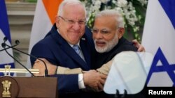 FILE - Israeli President Reuven Rivlin and India's Prime Minister Narendra Modi hug each other after reading their joint statement at Hyderabad House in New Delhi, India, Nov. 15, 2016.
