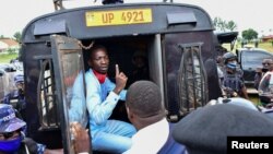 Ugandan presidential candidate Robert Kyagulanyi, also known as Bobi Wine, sits inside a police vehicle in Luuka district, eastern Uganda, Nov. 18, 2020. 