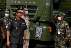 FILE - Son of Cambodian Prime Minister Hun Sen, Lt. Gen. Hun Manet, inspects military vehicles at ceremony at the National Olympic Stadium in Phnom Penh, Cambodia, June 18, 2020.