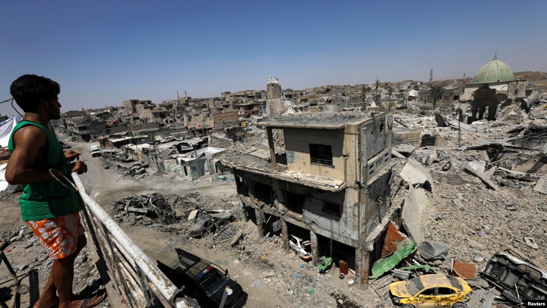 An Iraqi looks at the ruins of Grand al-Nuri Mosque and al-Hadba minaret in the destroyed Old City of Mosul, Iraq, Aug. 5, 2017. 