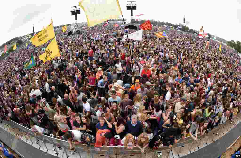 Festival-goers wait for a performance by Alabama Shakes on the Pyramid Stage on the first official date of the Glastonbury Festival of Music and Performing Arts on Worthy Farm near the village of Pilton in Somerset, England.