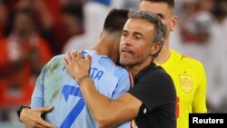 Luis Enrique, Spain's coach, hugs his player Alvaro Morata after they were eliminated out of the 2022 FIFA World Cup by Morocco through a penalty shootout in Al Rayyan, Qatar, Dec. 6, 2022.
