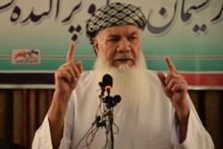 FILE - Afghan warlord and former mujahedeen leader Mohammed Ismail Khan addresses a gathering at his home in Herat, Afghanistan, July 9, 2021.