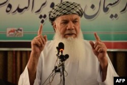 FILE - Afghan warlord and former mujahedeen leader Mohammed Ismail Khan addresses a gathering at his home in Herat, Afghanistan, July 9, 2021.