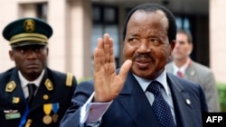 FILE - Cameroon's president, Paul Biya, waves as he arrives at an EU-Africa summit on April 3, 2014, at EU Headquarters in Brussels. In a rare public appearance, Biya on Friday paid homage to four top military officers killed in a helicopter crash last month and urged fellow citizens to unite in the fight against Boko Haram.