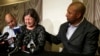 Former NFL player Dorsey Levens, right, extends a hand as Mary Ann Easterling, the widow of former NFL player Ray Easterling, reacts during a news conference, April 9, 2013, in Philadelphia, after a hearing to determine whether the NFL faces years of litigation over concussion-related brain injuries. 