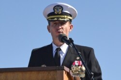 FILE - Captain Brett Crozier addresses the crew as commanding officer of the aircraft carrier USS Theodore Roosevelt in San Diego, California, March 1, 2020.