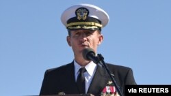 FILE - Capt. Brett Crozier addresses the crew for the first time as commanding officer of the aircraft carrier USS Theodore Roosevelt in San Diego, California, March 1, 2020. 