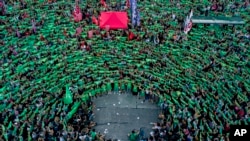 Pro-choice activists in favor of decriminalizing abortion raise green handkerchiefs as they rally outside Congress in Buenos Aires, Argentina, Feb. 19, 2019. A rise in global populism is threatening access to abortion, a group of female leaders warned Monday.