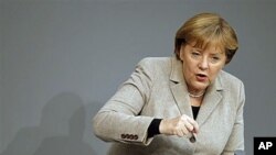 German Chancellor Angela Merkel gestures during her speech at the German federal parliament, the Bundestag, in Berlin, Germany, December 14, 2011.