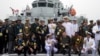 FILE - Foreign naval officers gather for a photo on the naval training ship Qi Jiguang before a parade to commemorate the 70th anniversary of the founding of China's PLA Navy April 23, 2019.