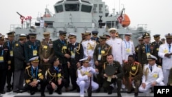 FILE - Foreign naval officers gather for a photo on the naval training ship Qi Jiguang before a parade to commemorate the 70th anniversary of the founding of China's PLA Navy April 23, 2019.