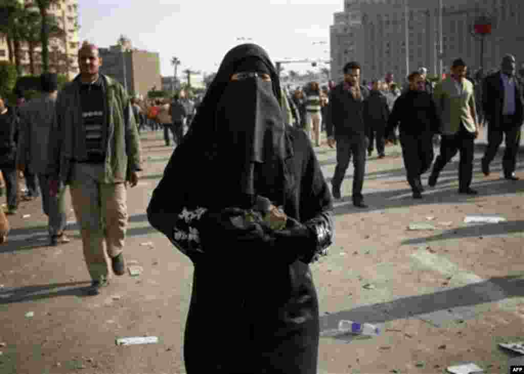 An anti-government protester carries rocks during clashes in Tahrir, or Liberation square, in Cairo, Egypt, Wednesday, Feb. 2, 2011. Several thousand supporters of President Hosni Mubarak, including some riding horses and camels and wielding whips, clashe