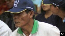 A disabled former Khmer Rouge soldier attends a discussion led by U.N. officials who are distributing printed copies of the final verdict of Case 001 against Kaing Guek Eav,also known as Duch, a former prison chief for the regime, in Anlong Veng, a forme