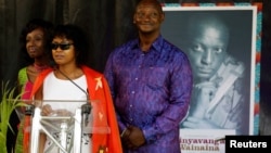 Family members of Kenyan writer and LGBT activist Kenneth Binyavanga Wainaina, who died in Nairobi last week at the age of 48, read his eulogy during a memorial service at the Nairobi national museum, in Nairobi, Kenya, May 30, 2019.