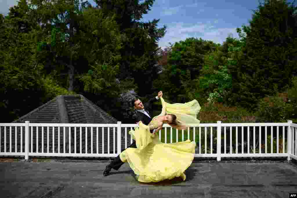 Ballroom dancers Roman Sukhomlyn and India Phillips, the North of England Champions at the British National Dance Championships, practice on their balcony at home in Wolverhampton, England.