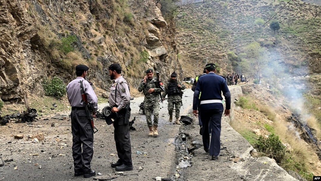 Security personnel inspect the site of a suicide attack near Besham city in the Shangla district of Khyber Pakhtunkhwa province on March 26, 2024.