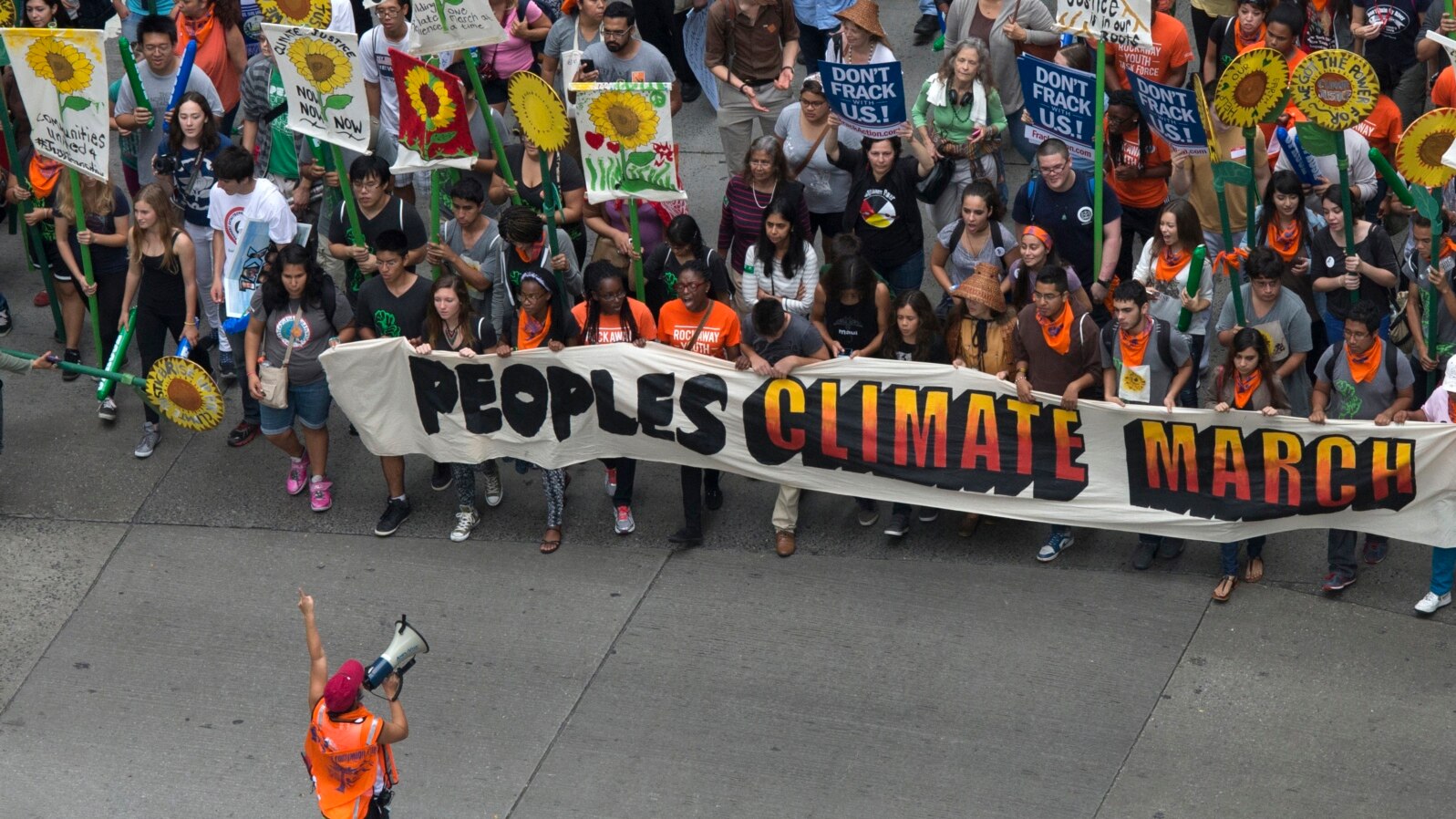 Activists hold a banner as they lead a march of tens of thousands down 6th Avenue during the People's Climate March through Midtown, New York, Sept. 21, 2014. 