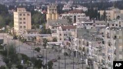 A damaged tank is seen at a street in Homs, April 12, 2012. Picture taken April 12, 2012. 