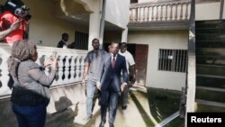 FILE - Maurice Kamto, leader of the Cameroon Renaissance Movement, walks out after a news conference in Yaounde, Cameroon, Oct. 8, 2018. A U.N. report accuses the Cameroon government of stifling him and his movement. 