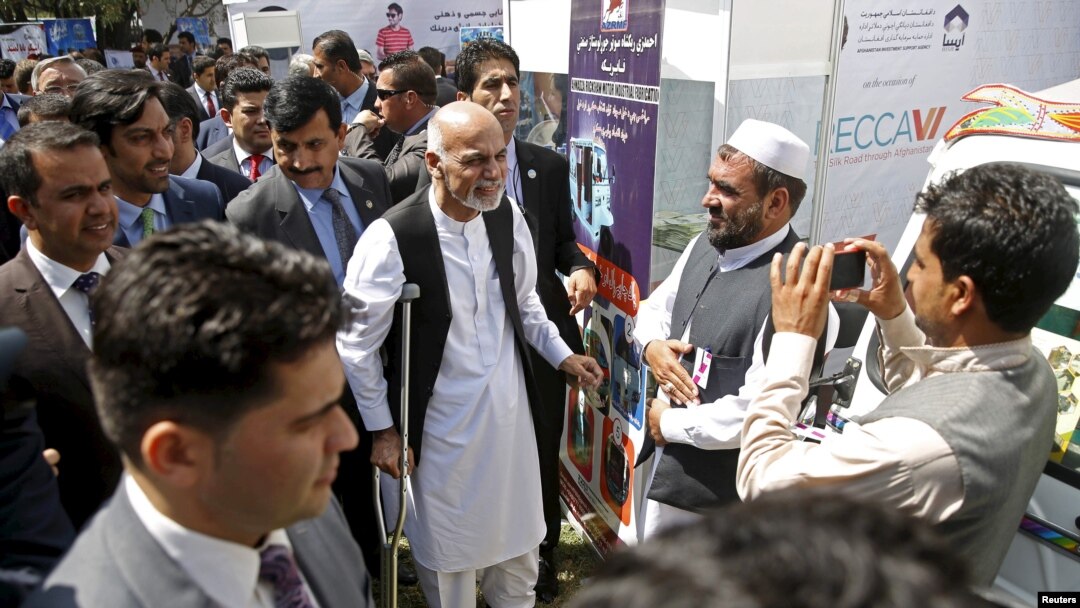 Afghan President Ashraf Ghani, using crutches after recent foot surgery, talks to participants at an exhibition of Afghanistan products during the Regional Economic Cooperation Conference of Afghanistan (RECCA) in Kabul, Afghanistan, Sept. 4, 2015.