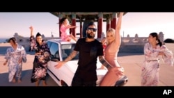 FILE - This photo provided by AZ Films shows California-based Iranian pop singer Sasy with American adult film actress Alexis Texas in the music video for "Tehran Tokyo," on Feb 26, 2021, in Los Angeles.