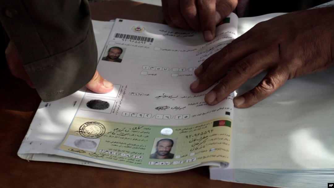 FILE - An Afghan man marks his application for voter registration with his fingerprint, Sept. 16, 2013.