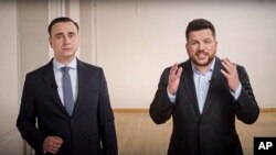 In this image taken from a video released by Alexei Navalny Youtube Channel on April 18, 2021, Leonid Volkov, a top strategist for Navalny, right, and his colleague Ivan Zhdanov record their address from somewhere in Europe. 